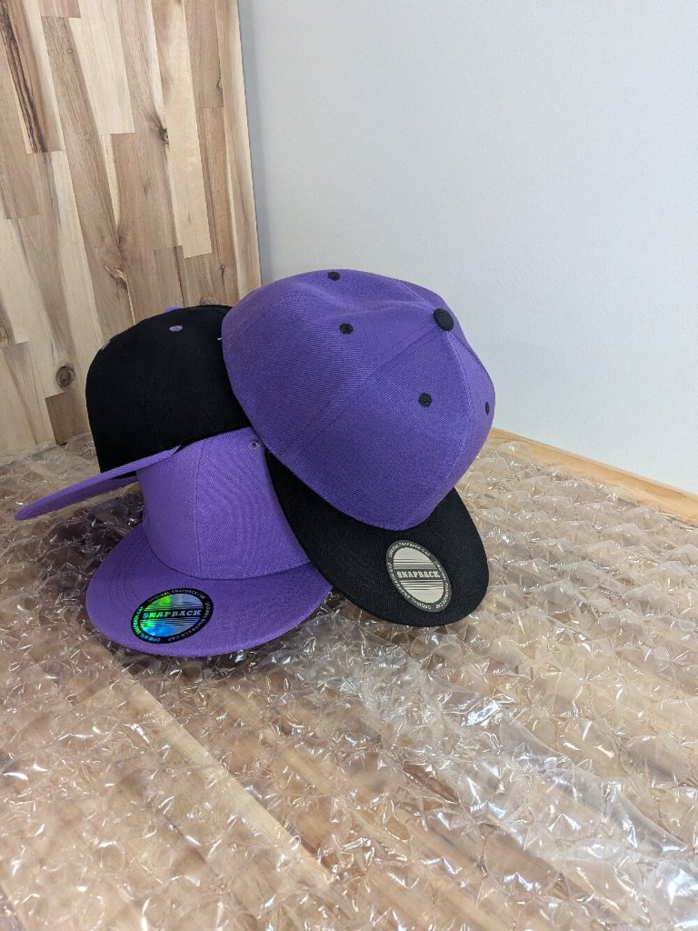 Purple and black baseball caps.